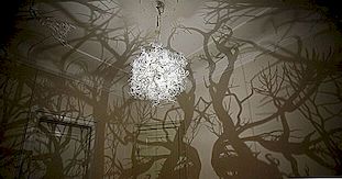 复杂的枝形吊灯在墙壁上投下神秘的森林场景